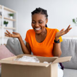 Woman opening a package that was delivered at home