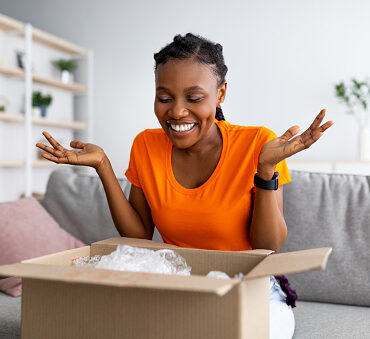 Woman opening a package that was delivered at home