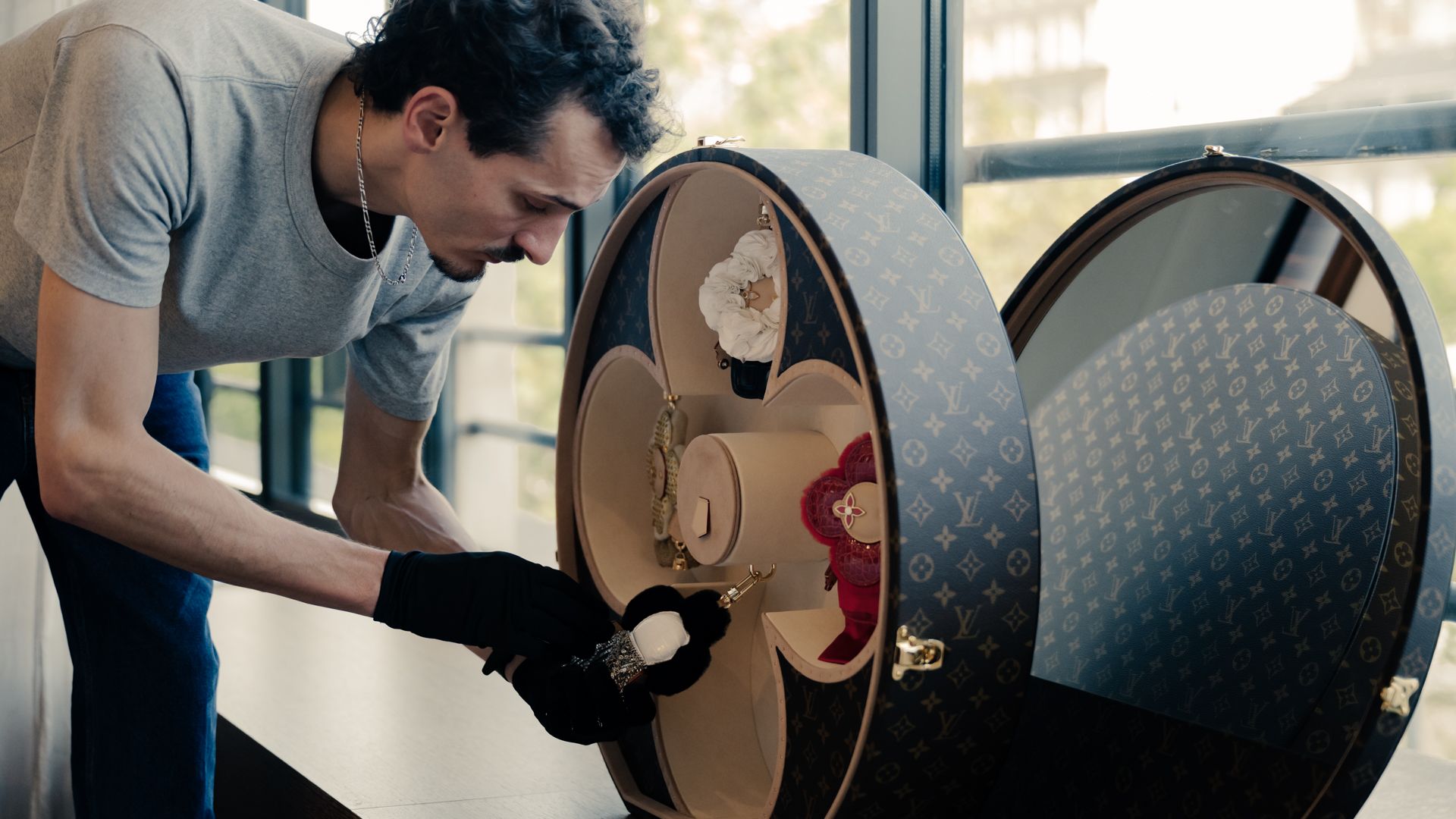 Craftsmanship demonstration involving a circular Louis Vuitton case