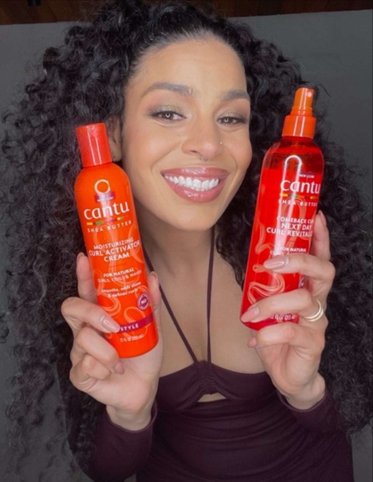Jordin Sparks holding two cantu hair products