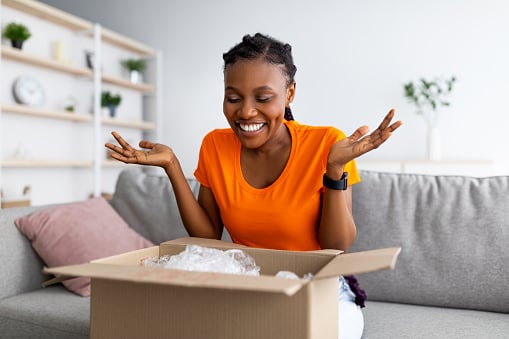 Woman opening a package that was delivered at home