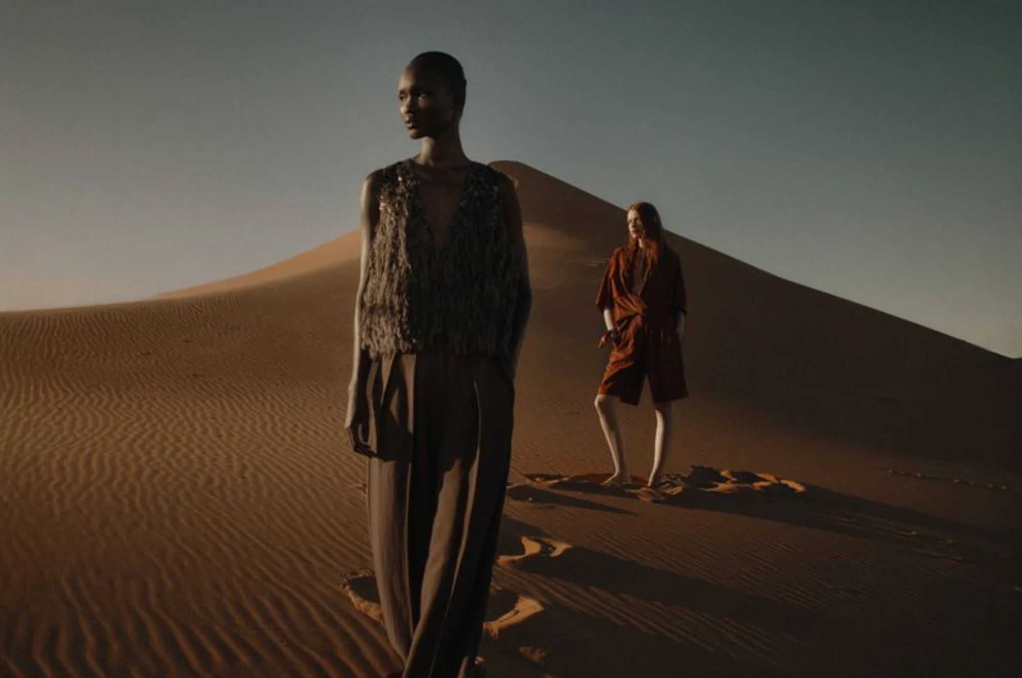 Brunello Cucinelli Spring/Summer 2026 models in a desert landscape.