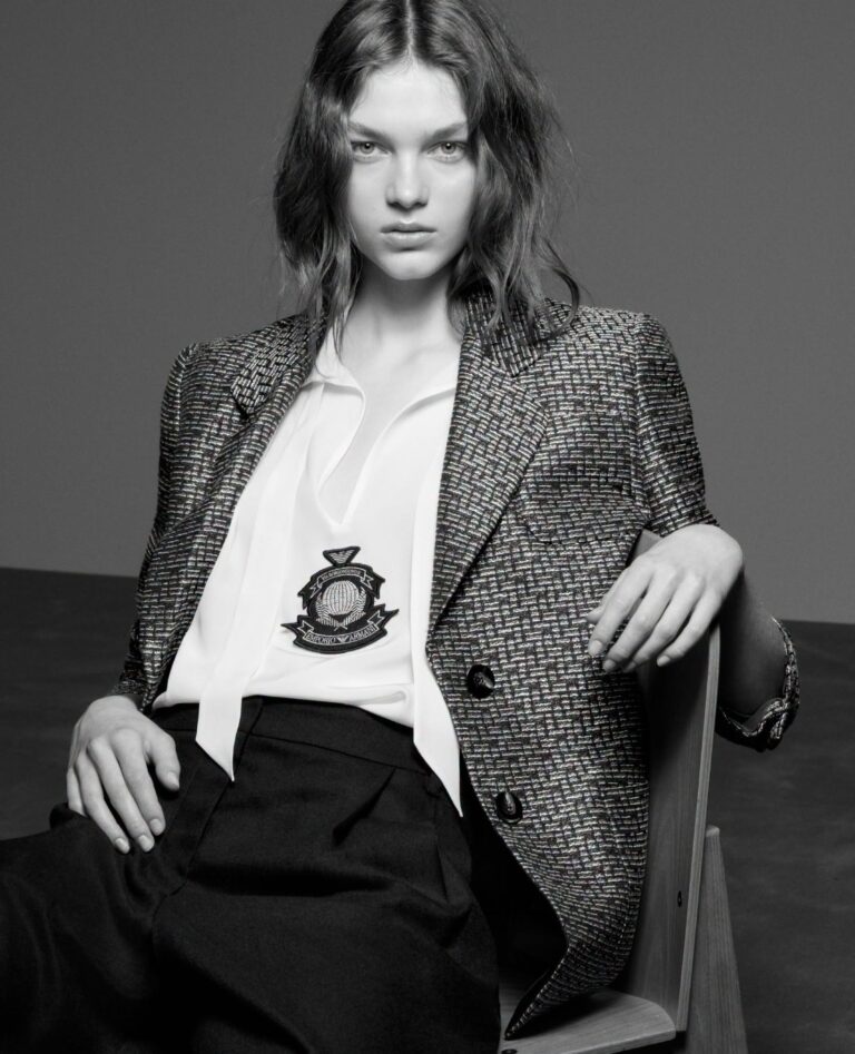 Model wearing Emporio Armani houndstooth blazer with crest emblem from the Fall-Winter 2026-27 collection