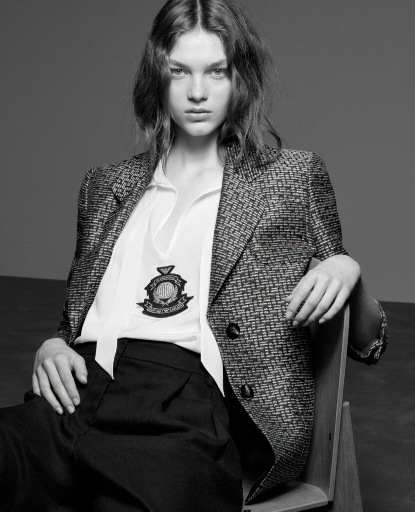 Model wearing Emporio Armani houndstooth blazer with crest emblem from the Fall-Winter 2026-27 collection