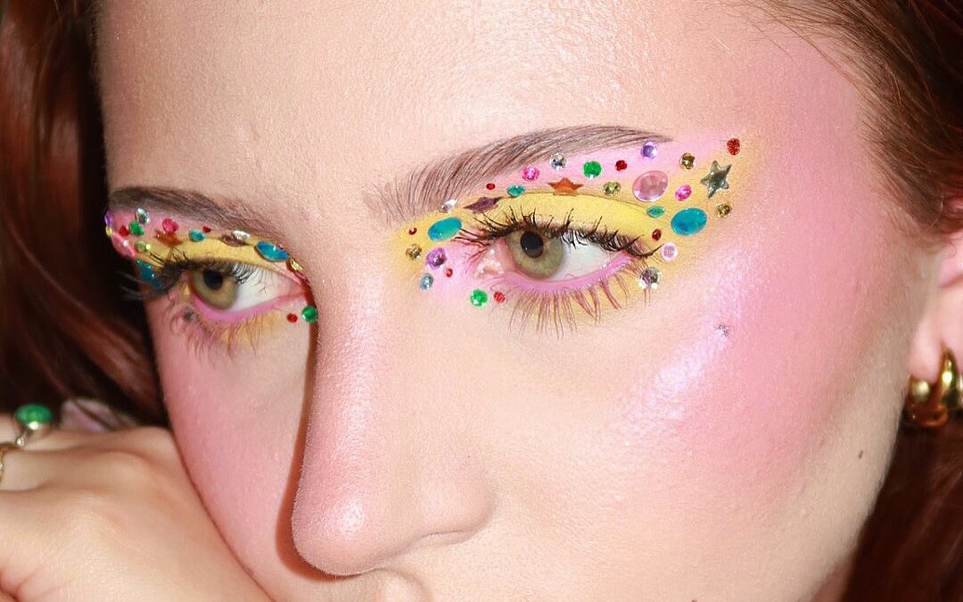 Whimsymaxxing beauty look featuring colorful rhinestones and playful makeup
