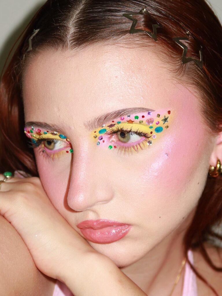 Whimsymaxxing beauty look featuring colorful rhinestones and playful makeup