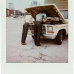 Two people in jeans beside a truck in the Wrangler × imogene + willie campaign
