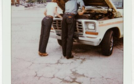 Two people in jeans beside a truck in the Wrangler × imogene + willie campaign
