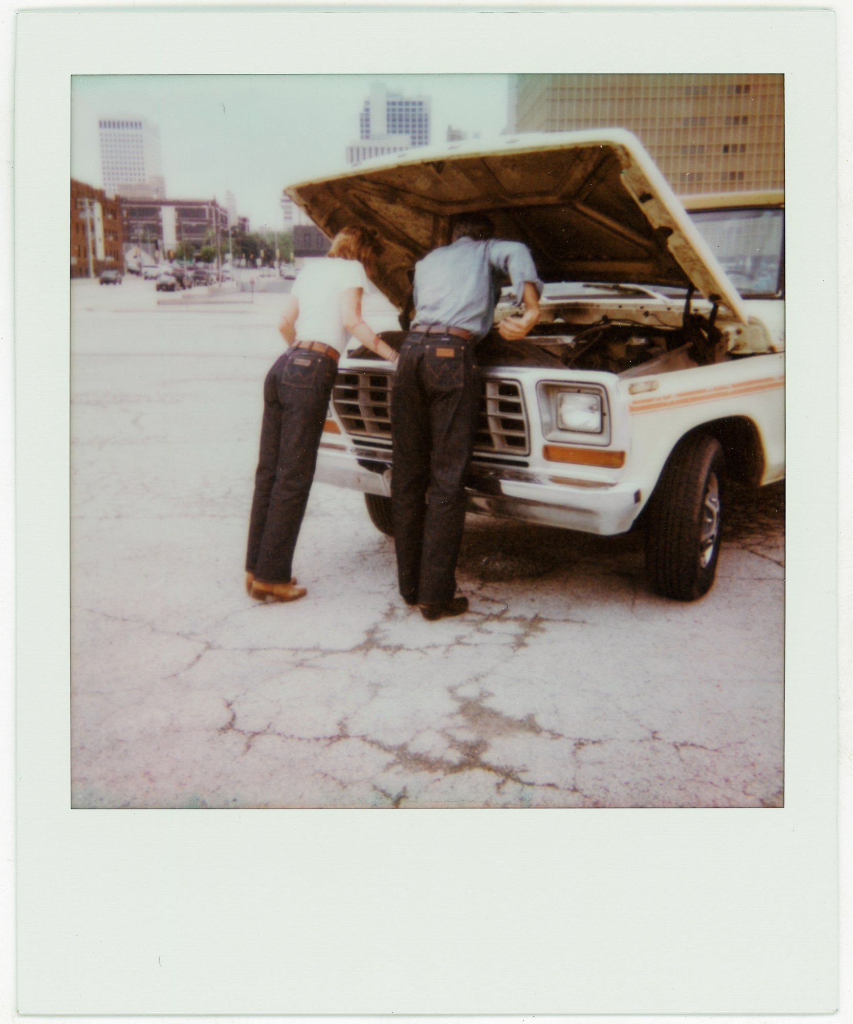 Two people in jeans beside a truck in the Wrangler × imogene + willie campaign