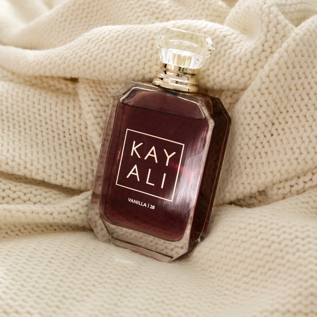 KAYALI Vanilla | 28 fragrance bottle photographed on knit fabric