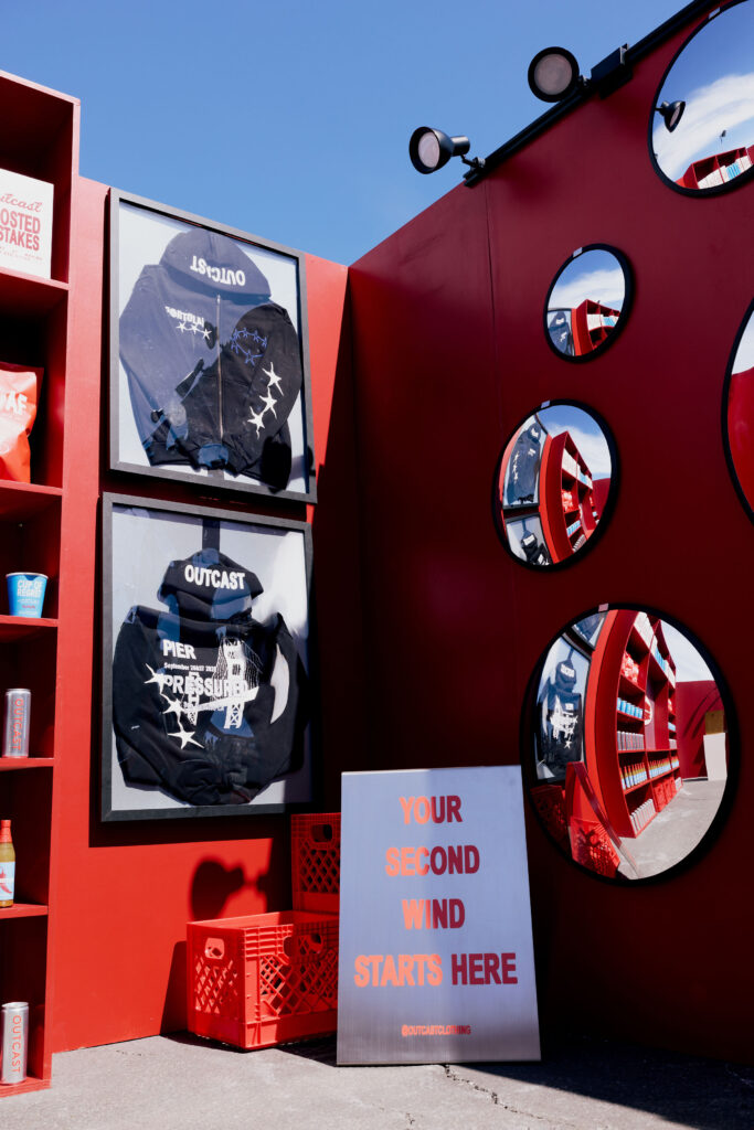 Framed Hoodies & Second Wind Sign Corner Vertical Shot at Outcast Clothing’s Portola Festival pop-up
