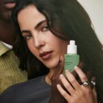 Model holding PHLUR Matcha Milk hair and body fragrance mist