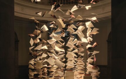 Suspended book pages above a fragrance display at Aesop’s Of Scent and Stanza exhibition in Tokyo