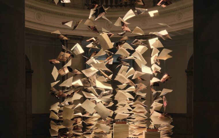 Suspended book pages above a fragrance display at Aesop’s Of Scent and Stanza exhibition in Tokyo