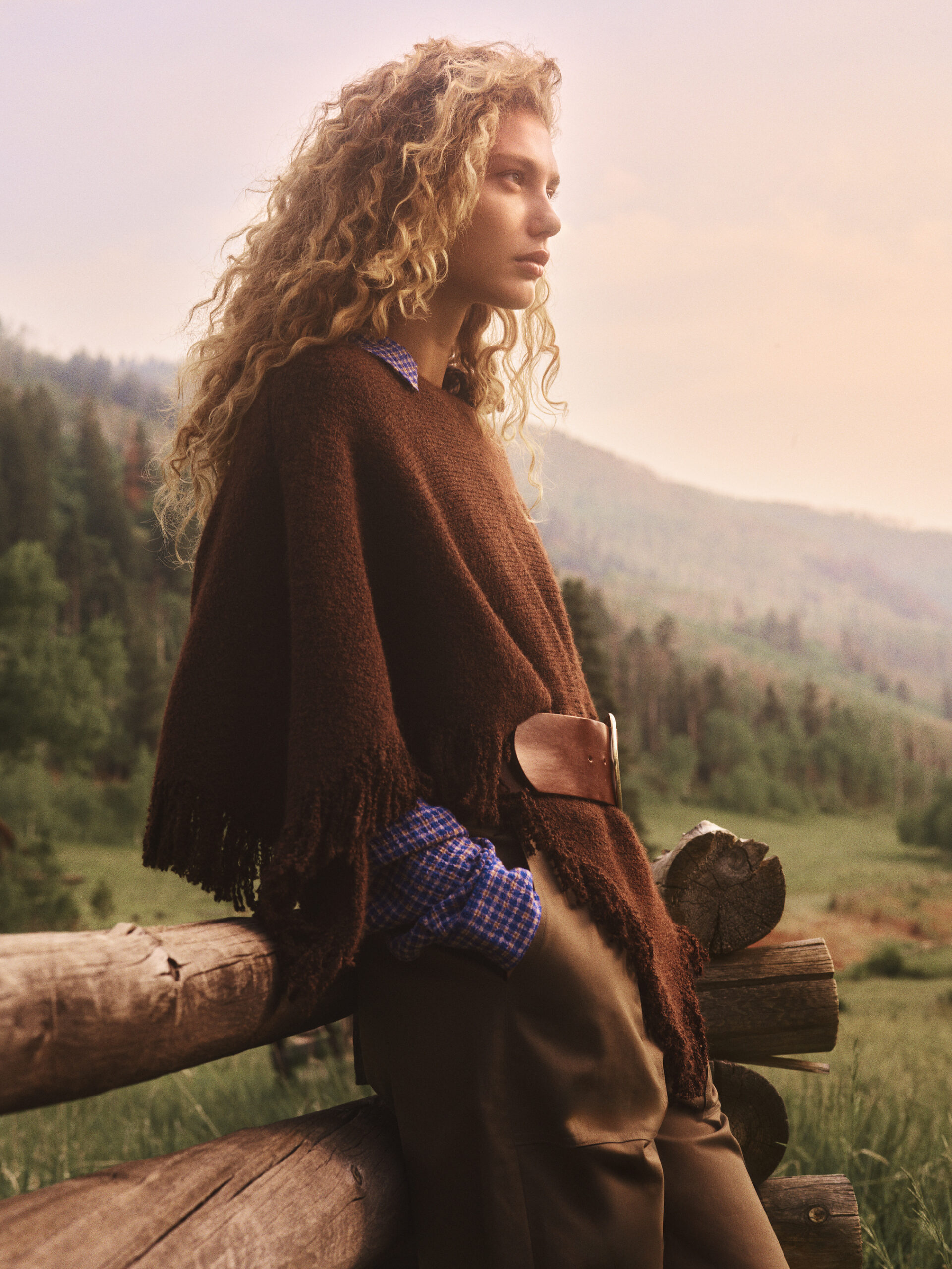 Anthropologie fall campaign model beside a wooden fence.
