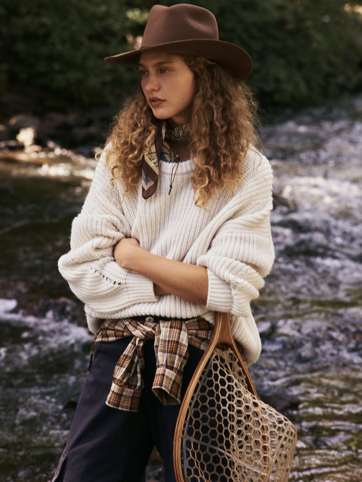Anthropologie Fall Is a Feeling campaign: cream knit sweater with a brown hat and plaid shirt