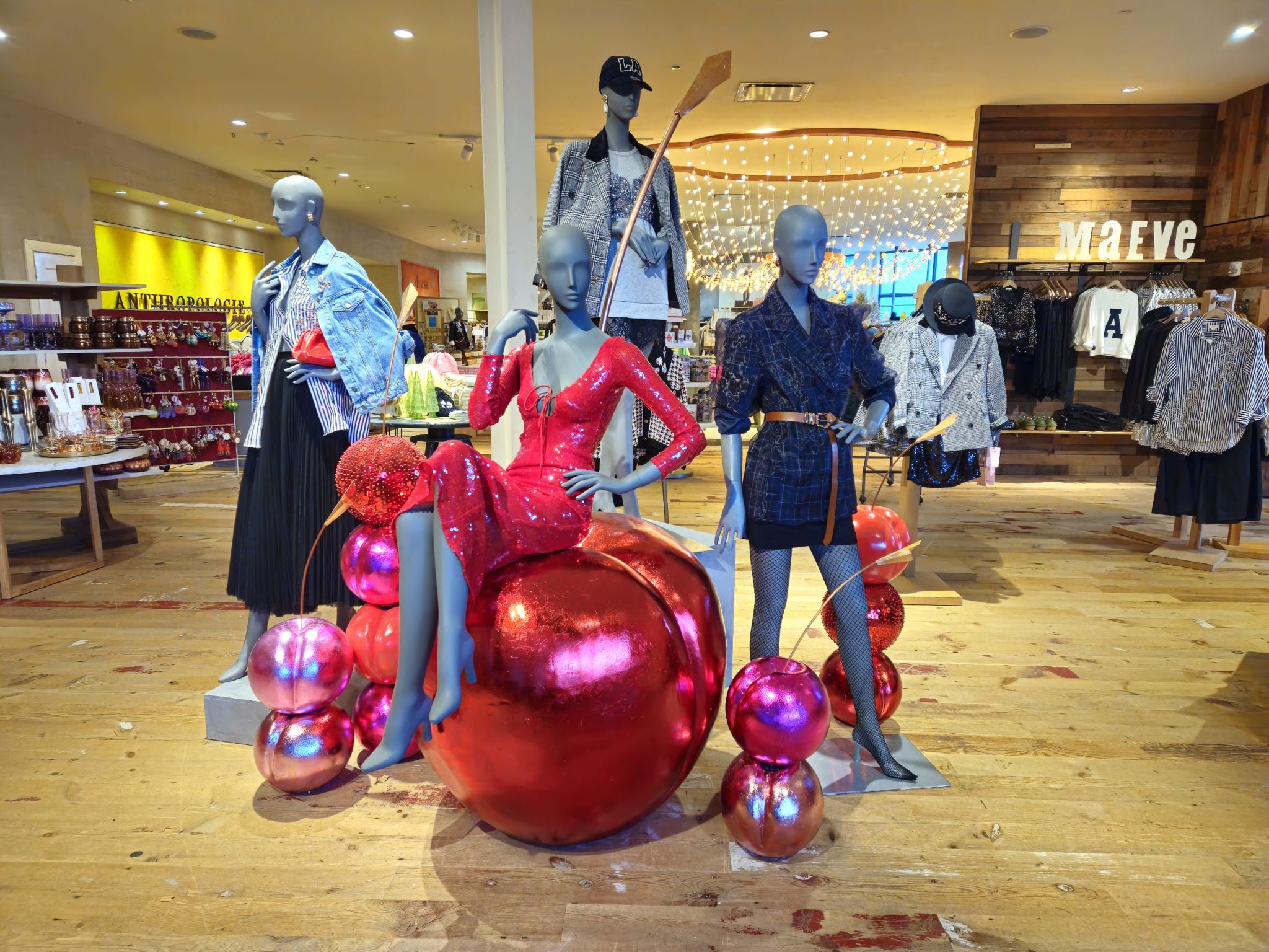 Anthropologie mannequins arranged among oversized glossy red sculptural forms