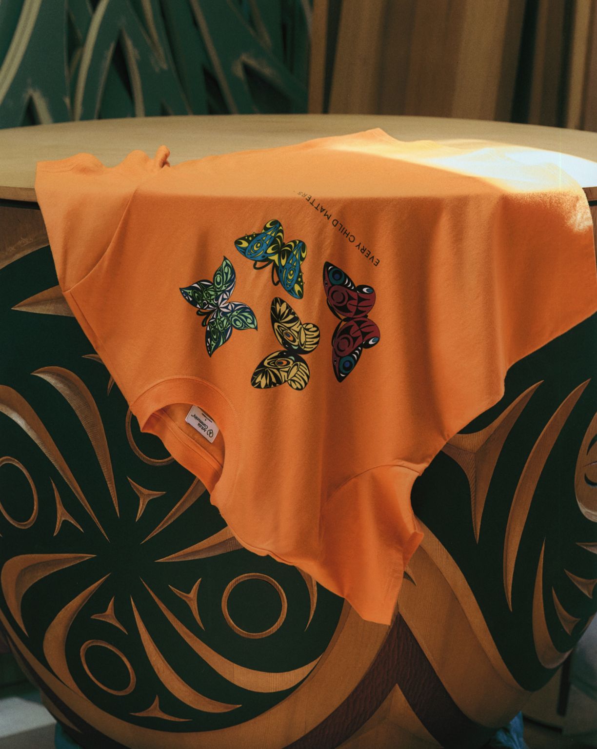 Orange Every Child Matters T-shirt featuring Susan Point’s butterfly artwork