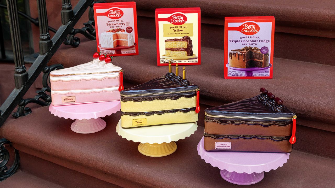 Three Betty Crocker cake-slice handbags displayed with corresponding cake mix boxes