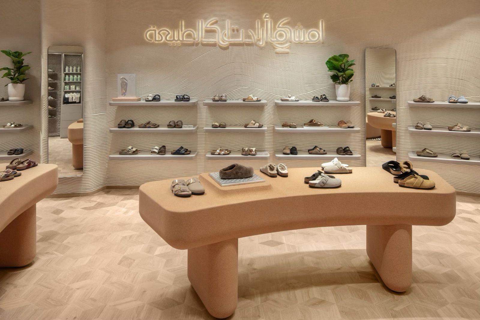 Birkenstock footwear displays beneath Arabic calligraphy at the Dubai store