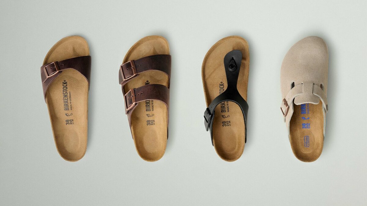 Four classic Birkenstock sandals photographed from above, showing their contoured footbeds