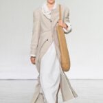 Bottega Veneta Summer 2027 runway look with light tailoring and woven bag