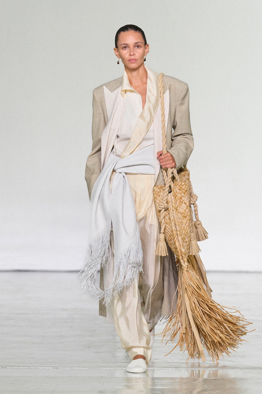 Bottega Veneta Summer 2027 layered tailoring with a fringed woven bag