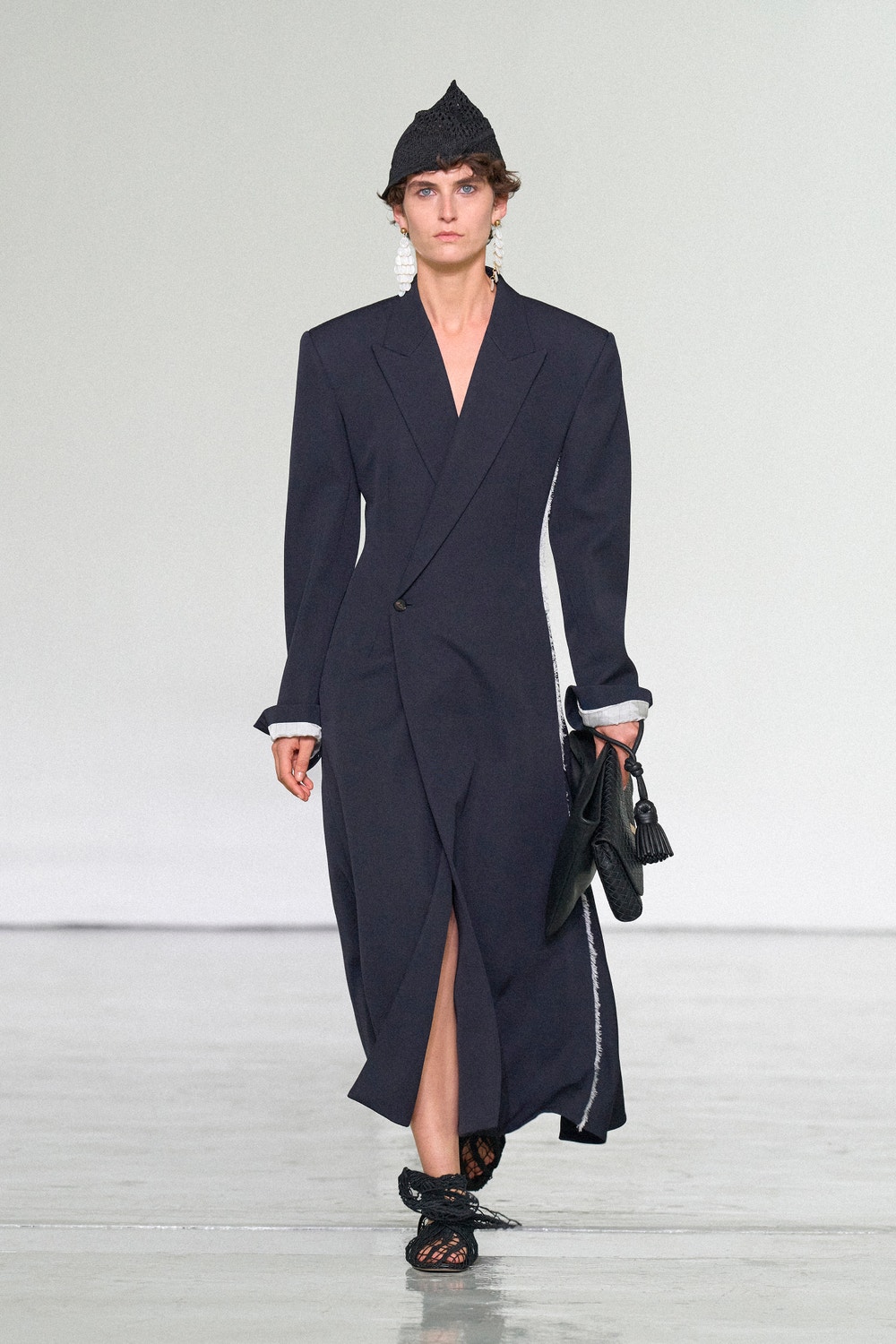 Bottega Veneta Summer 2027 navy coat and black handbag