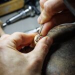Buccellati artisan setting a stone in a jewelry atelier