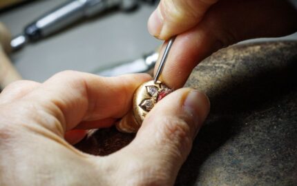 Buccellati artisan setting a stone in a jewelry atelier