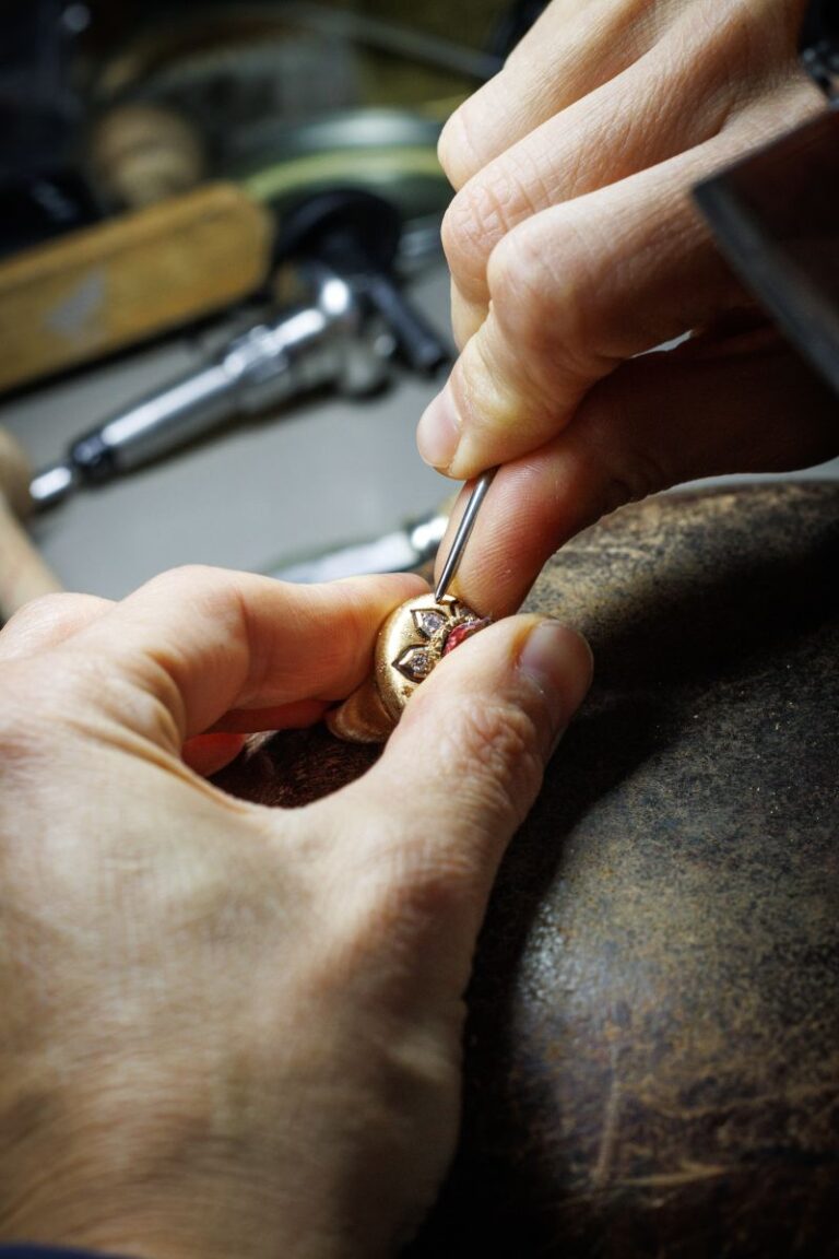 Buccellati artisan setting a stone in a jewelry atelier