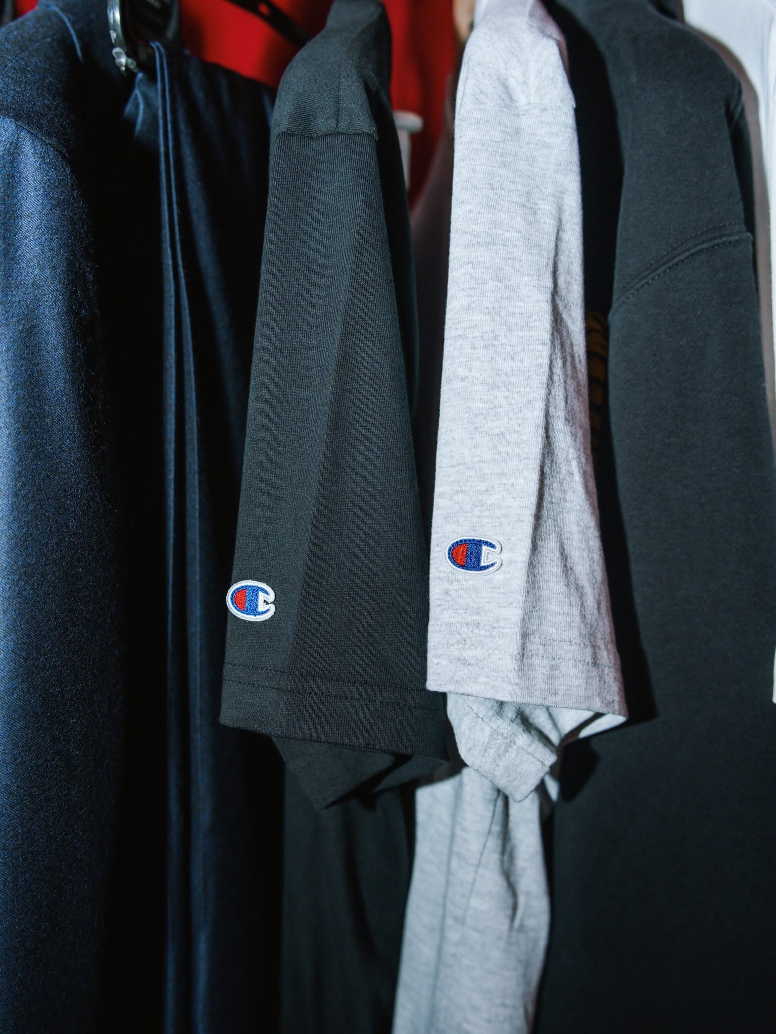 Champion logo details on garments from the collection.