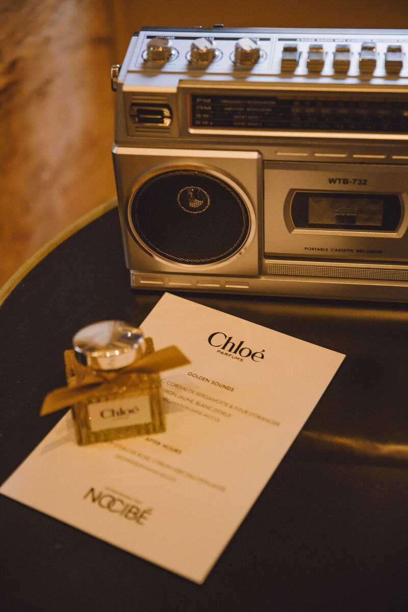 Chloé Le Nectar bottle and Nocibé event card beside a vintage radio