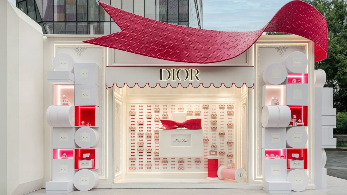 Exterior of a Miss Dior Eau de Parfum pop-up with a large red bow
