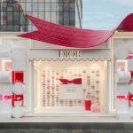 Exterior of a Miss Dior Eau de Parfum pop-up with a large red bow