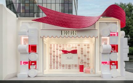 Exterior of a Miss Dior Eau de Parfum pop-up with a large red bow