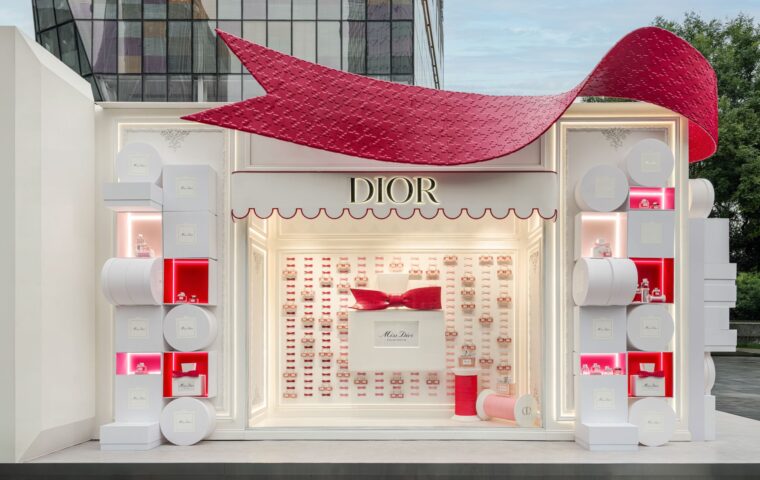 Exterior of a Miss Dior Eau de Parfum pop-up with a large red bow