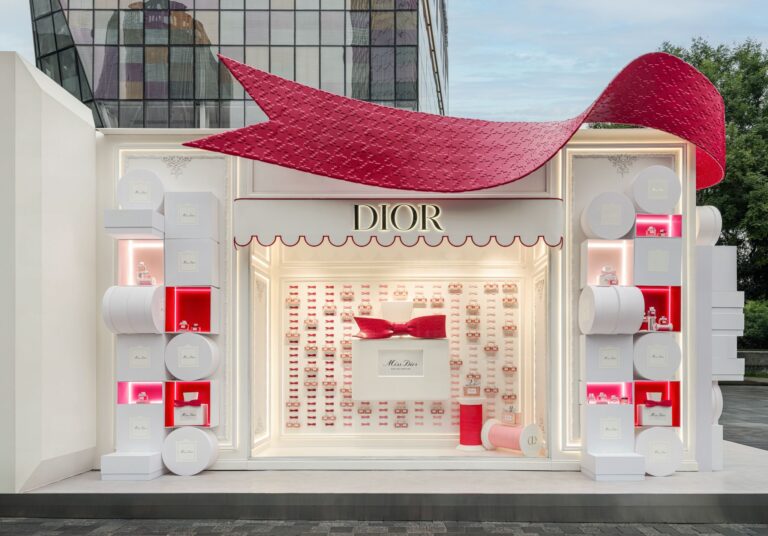 Exterior of a Miss Dior Eau de Parfum pop-up with a large red bow