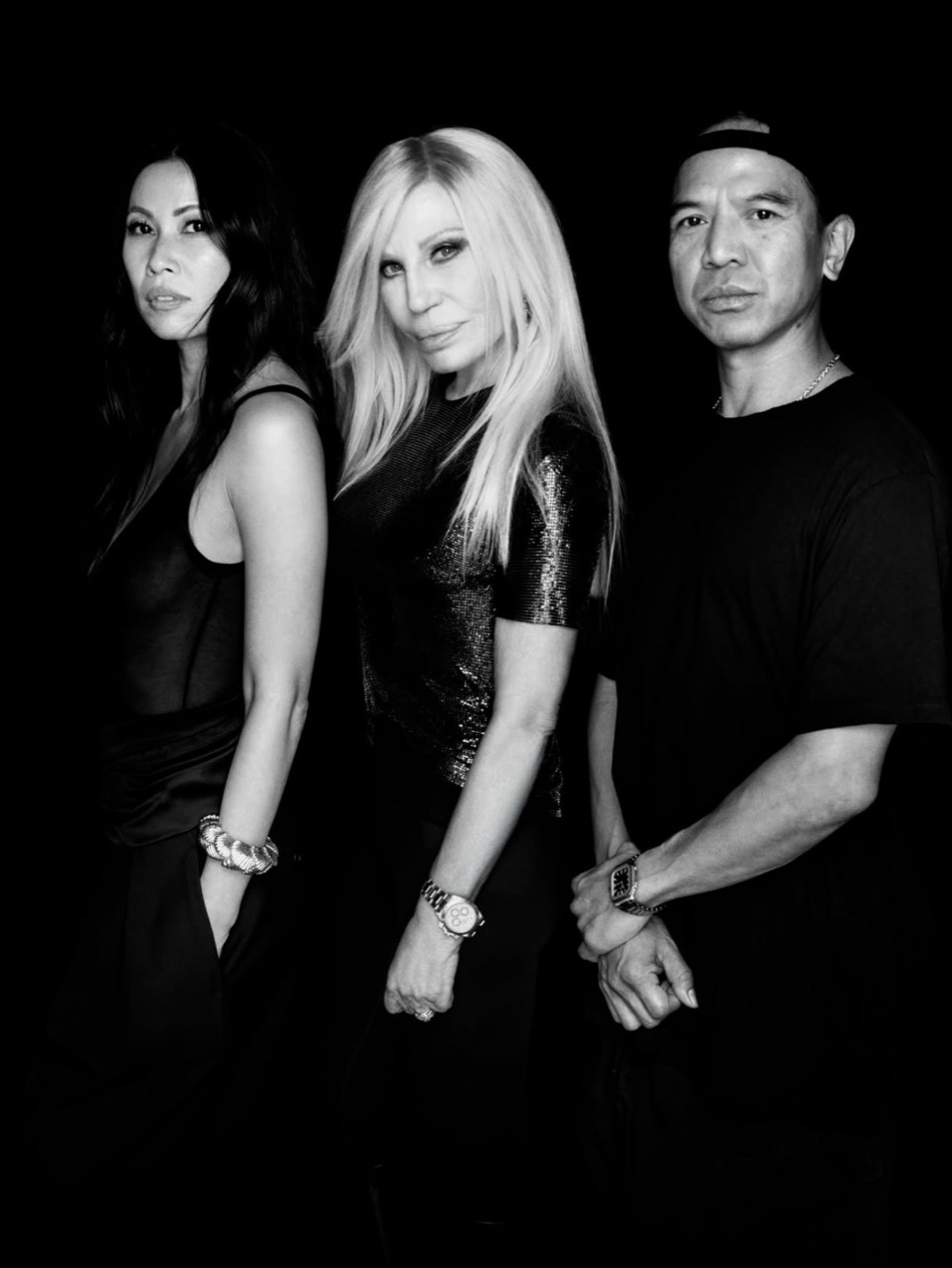 Raissa Gerona, Donatella Versace and Michael Mente in a black-and-white group portrait