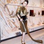 Guest at Ferragamo's new LANDMARK Hong Kong boutique with footwear displays behind her