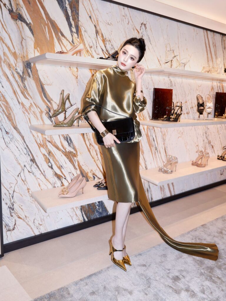 Guest at Ferragamo's new LANDMARK Hong Kong boutique with footwear displays behind her
