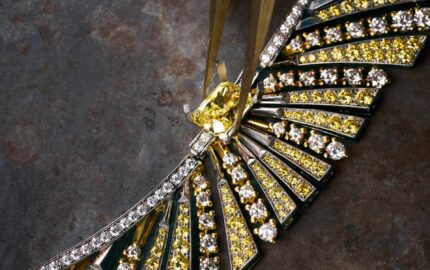 An artisan working on a FRED jewel with yellow and white stones