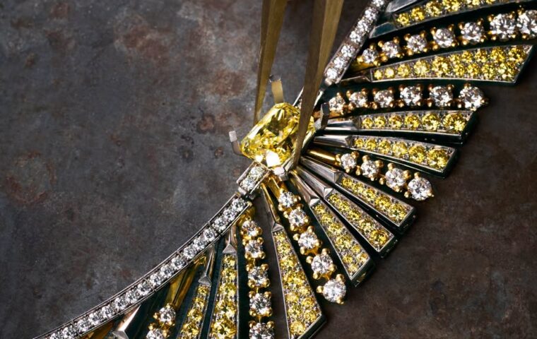 An artisan working on a FRED jewel with yellow and white stones