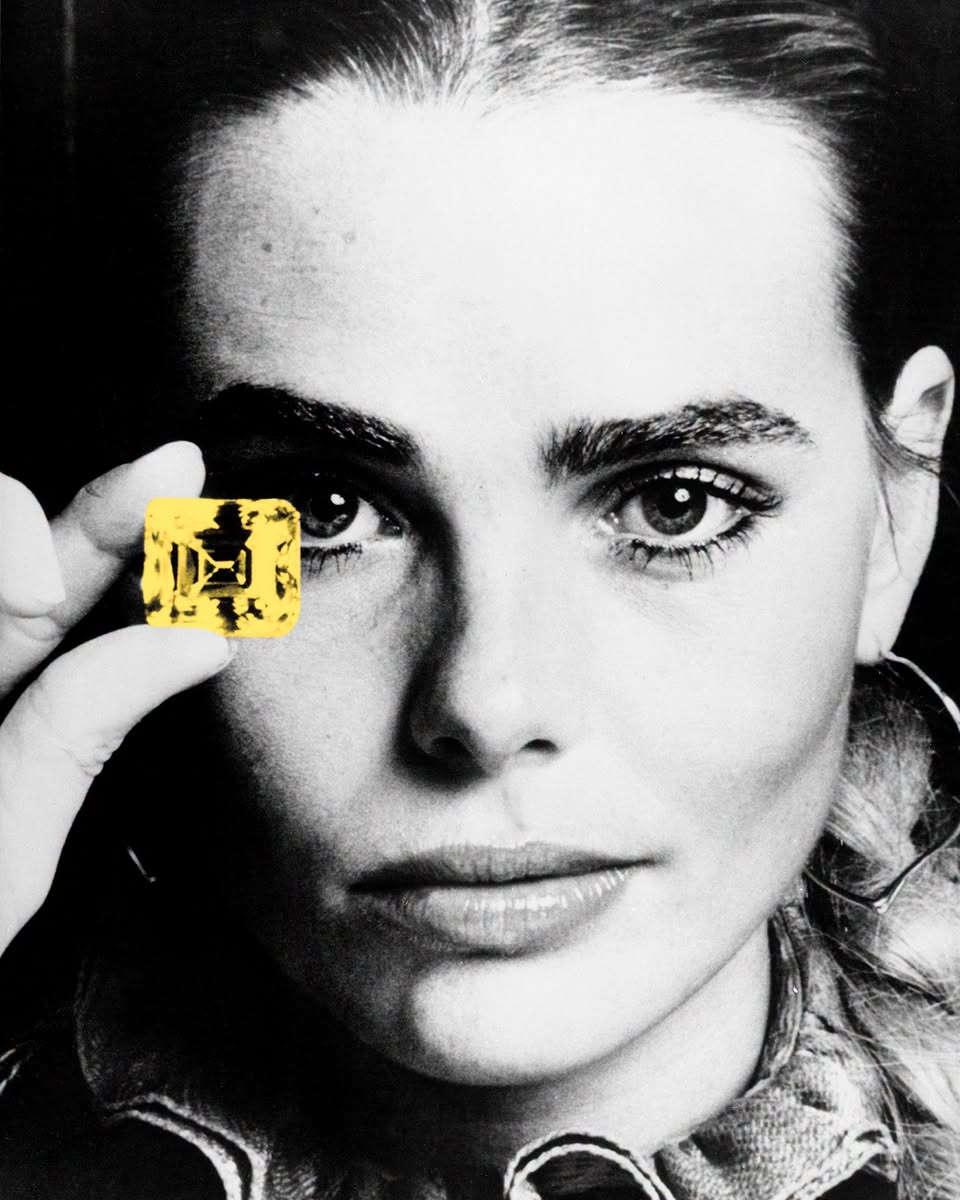 Archival FRED image of a woman holding a yellow gemstone