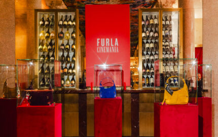 Furla Cinemania venue with Lynette bags displayed on red plinths