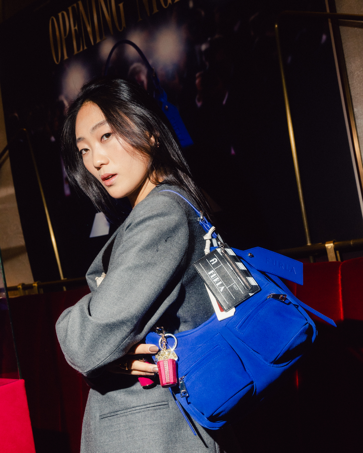 Guest with a blue Furla Lynette bag at Furla Cinemania