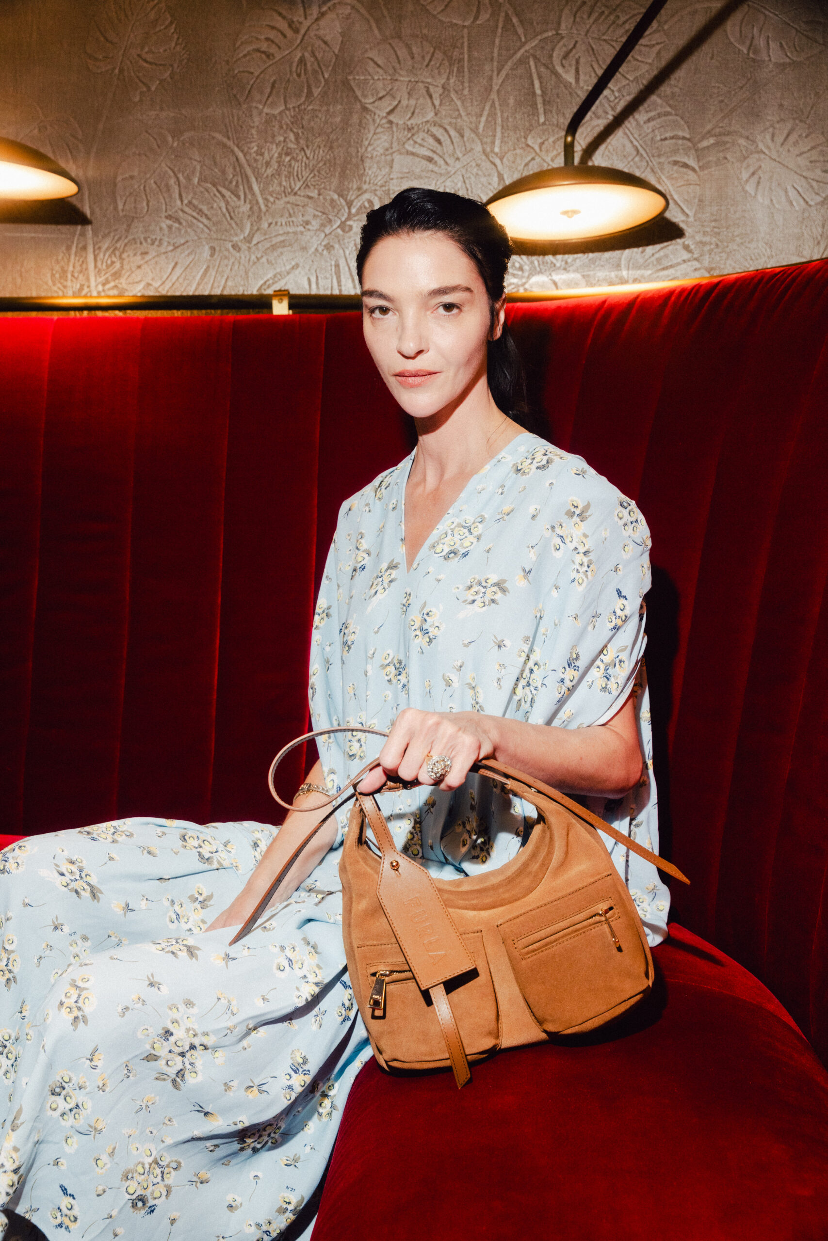 Guest seated with a Furla Lynette bag at Furla Cinemania