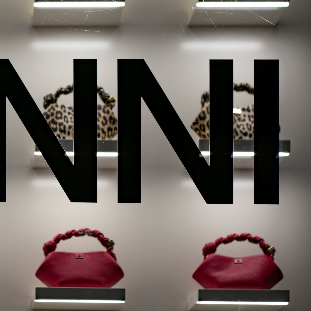 GANNI Bou bags framed by oversized GANNI window graphics and shelf lighting