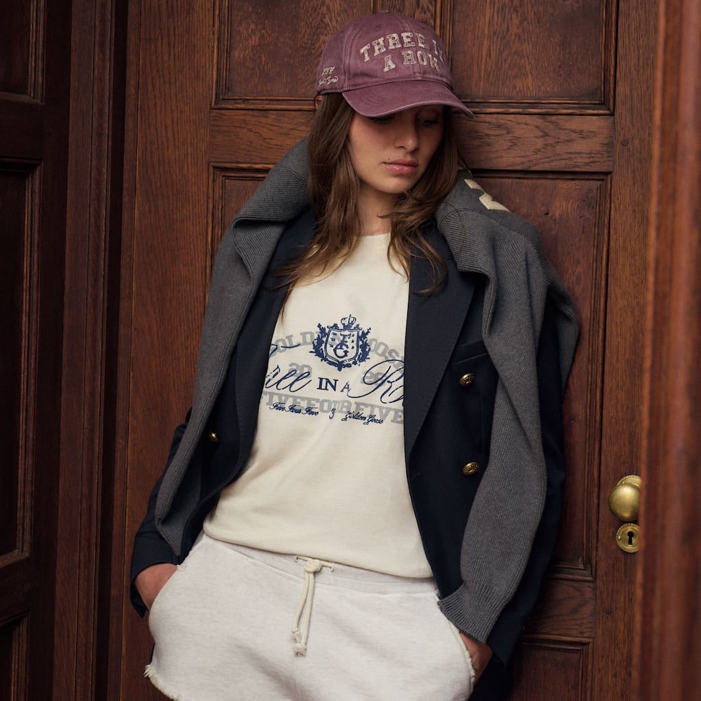 Model wearing Golden Goose x FiveFourFive varsity-inspired 2026 collection