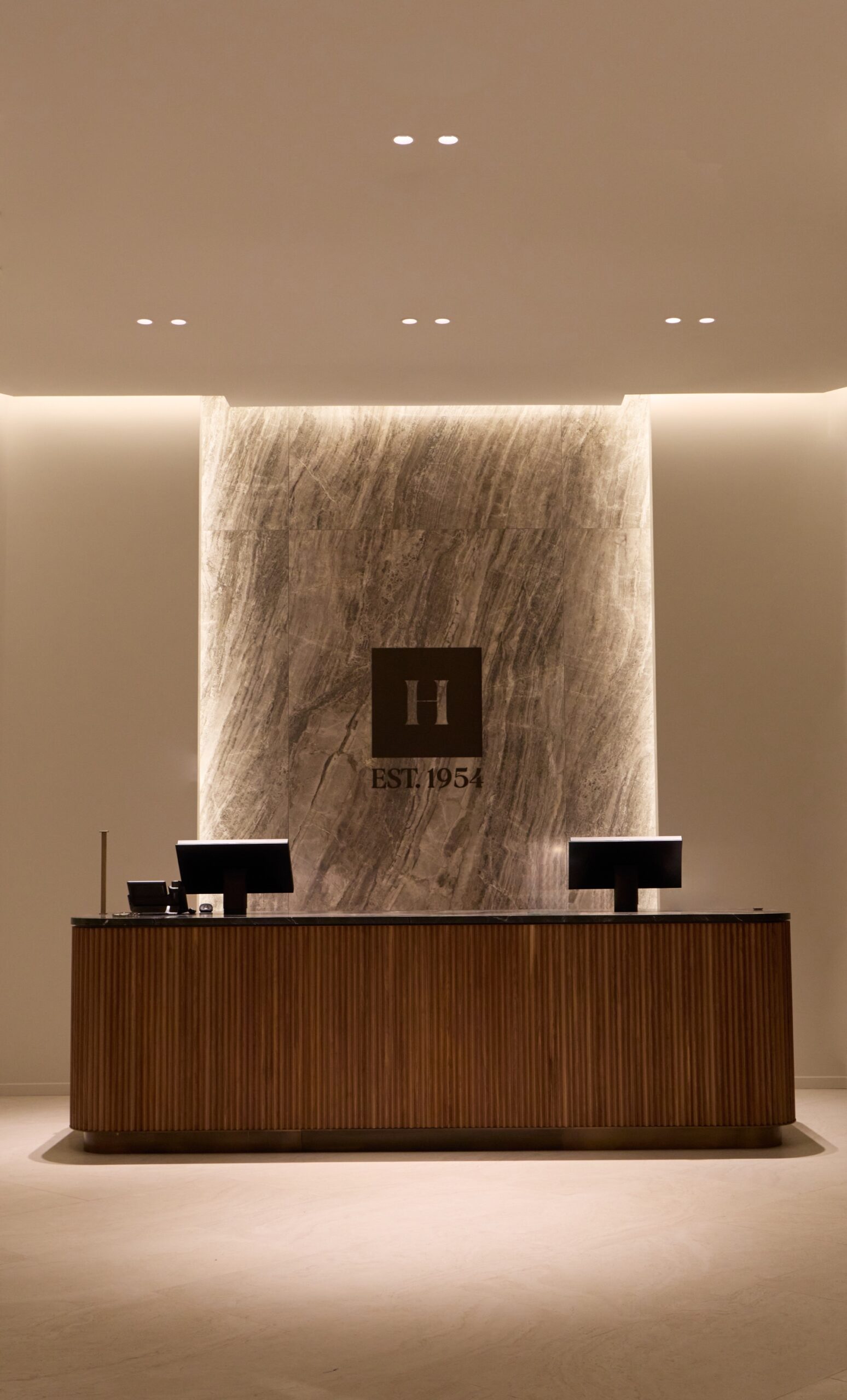 Minimal wood reception desk in the Harry Rosen flagship